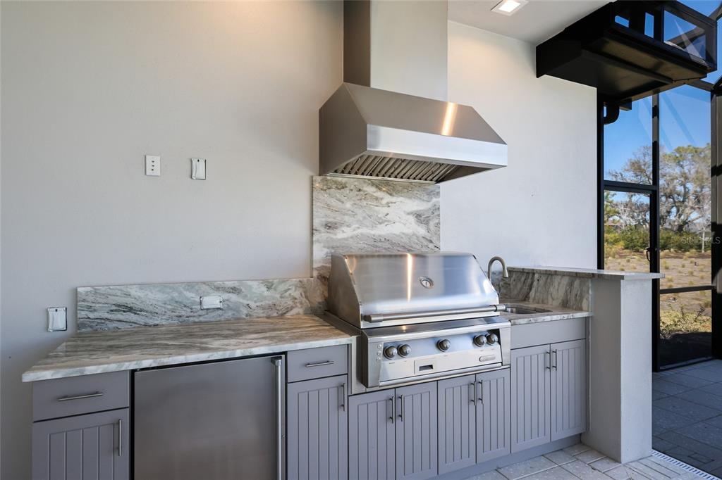 1107 Blue Shell Loop Sarasota, FL 34240 - Photo 56 of 88 a kitchen with stainless steel appliances granite countertop a stove and a sink