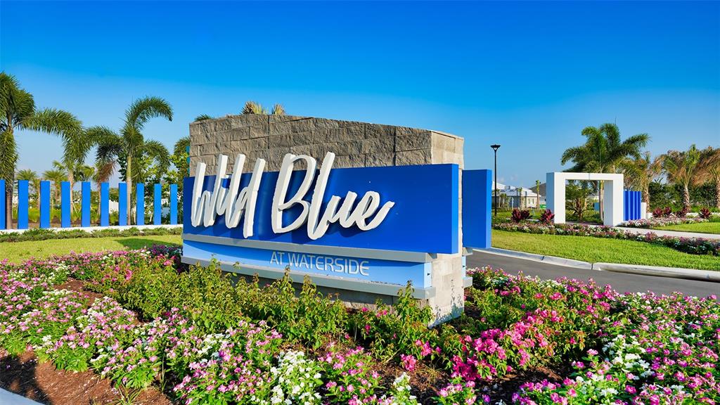1107 Blue Shell Loop Sarasota, FL 34240 - Photo 61 of 88 a view of sign board with buildings in the background