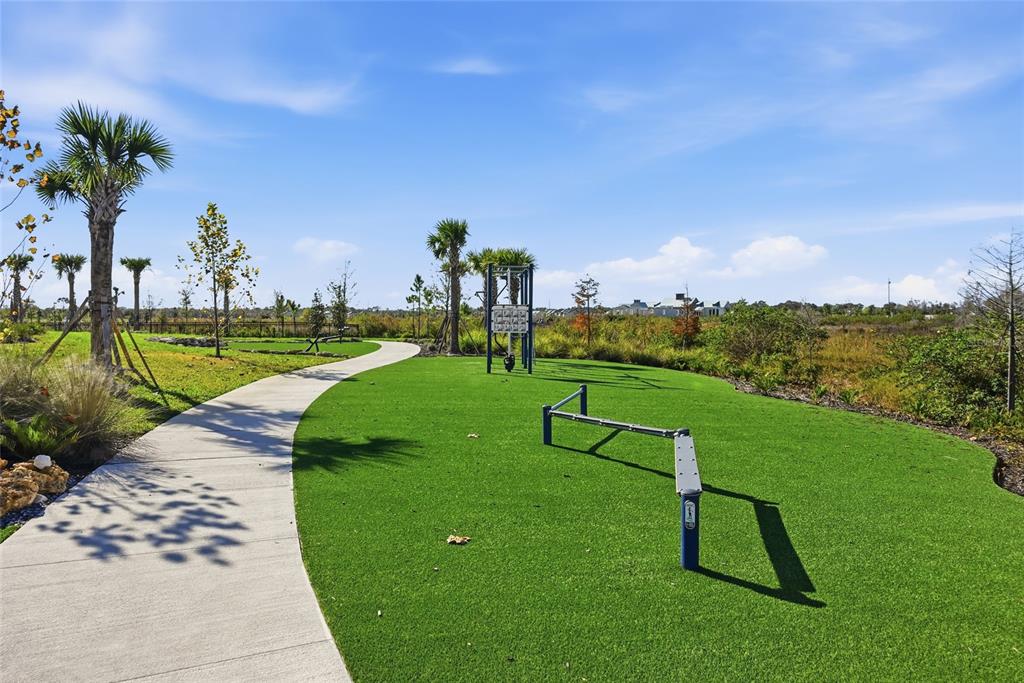 1107 Blue Shell Loop Sarasota, FL 34240 - Photo 78 of 88 a view of a golf course with a lake