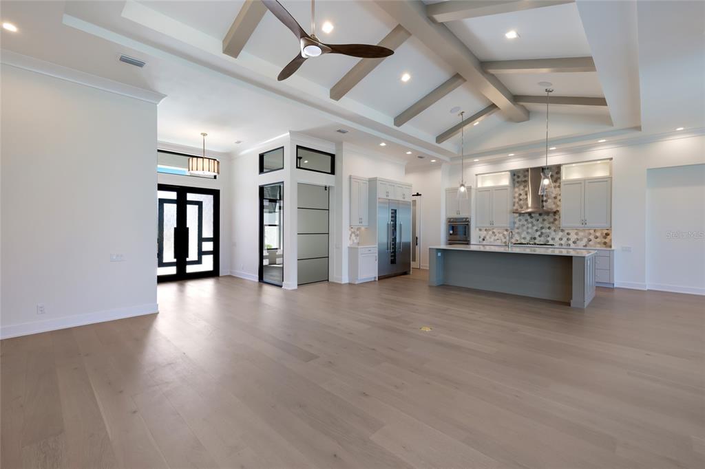 1107 Blue Shell Loop Sarasota, FL 34240 - Photo 8 of 88 a view of an empty room with window and wooden floor