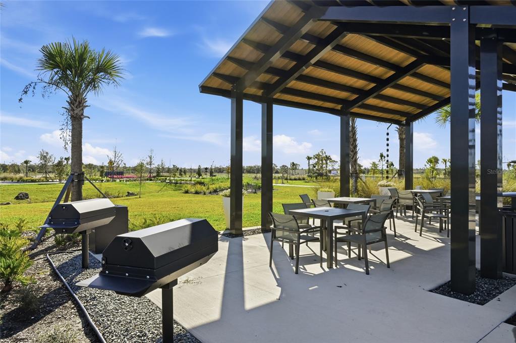 1107 Blue Shell Loop Sarasota, FL 34240 - Photo 86 of 88 a view of a chairs and table in patio with a lake view
