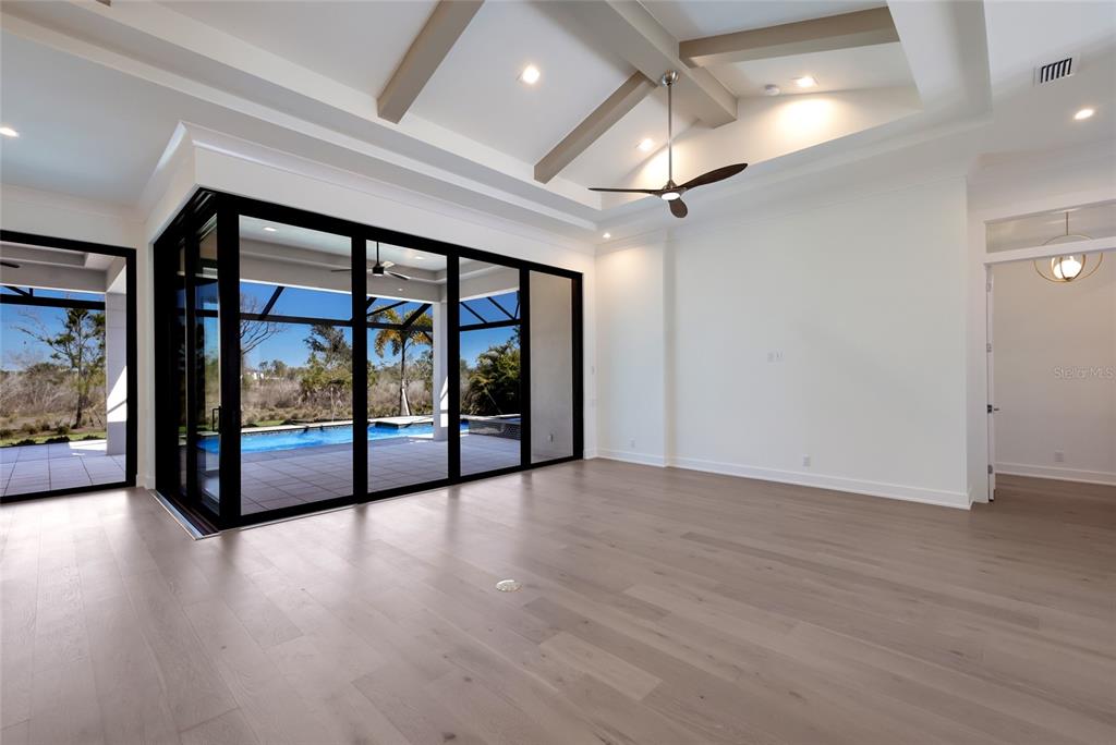1107 Blue Shell Loop Sarasota, FL 34240 - Photo 9 of 88 a view of an empty room with window wooden floor and door