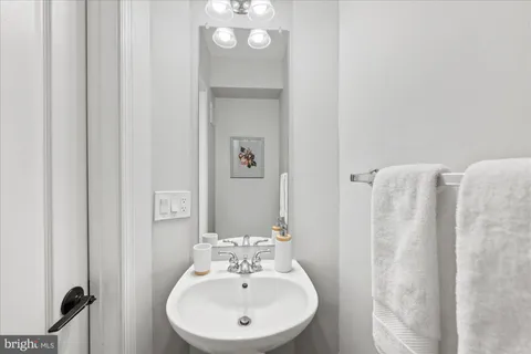 a bathroom with a sink a mirror and shower curtain