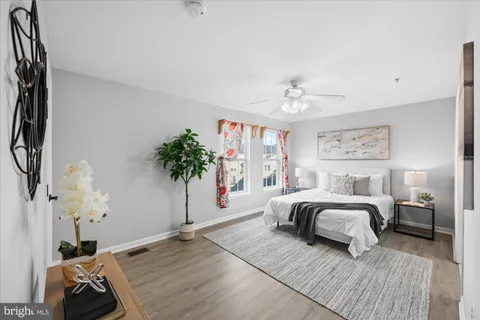 a spacious bedroom with a bed and a chandelier