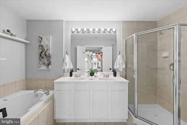 a bathroom with a sink a toilet a mirror and shower