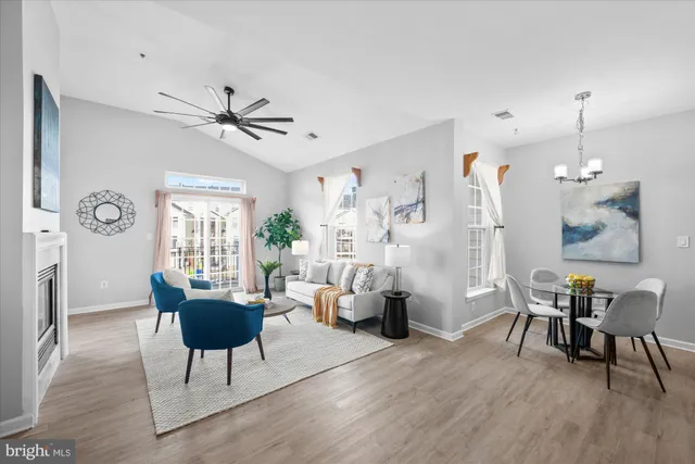 a living room with furniture a window and wooden floor