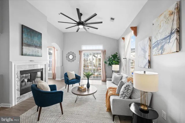 a living room with furniture and a fireplace
