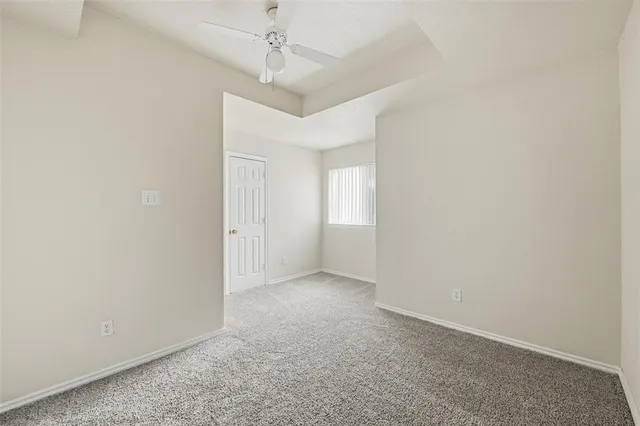 an empty room with a empty space and a ceiling fan