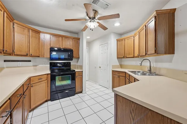 a kitchen with stainless steel appliances a stove sink microwave and cabinets