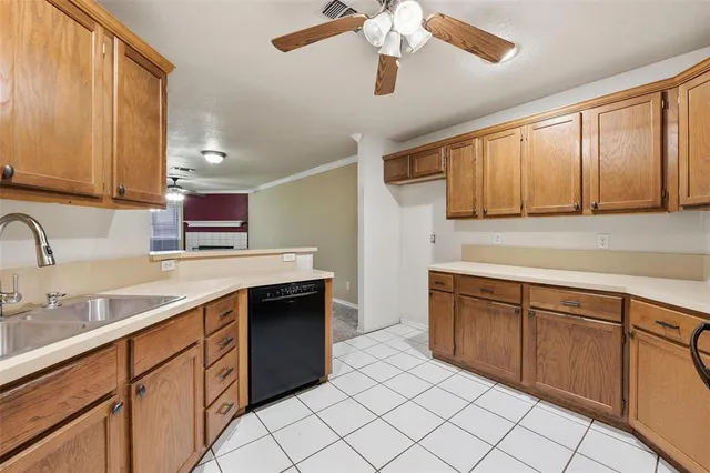 a kitchen with a sink cabinets and window
