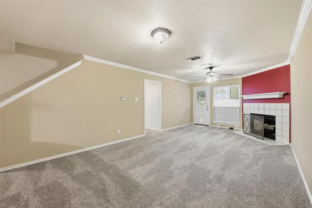 a view of empty room with fireplace