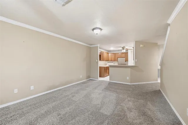 a view of a big room with chandelier fan and a bathroom