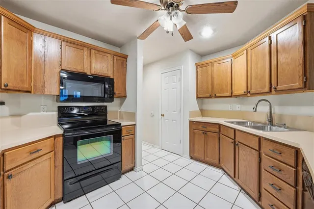 a kitchen with stainless steel appliances granite countertop a stove microwave and sink