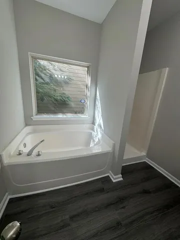 a bathroom with a bathtub and a window