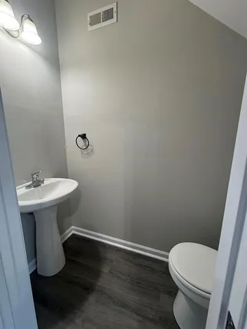 a bathroom with a sink toilet and a mirror
