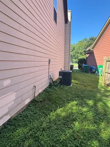 a view of a field with a trees in the background