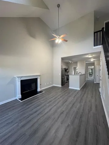 a view of empty room with wooden floor and fireplace