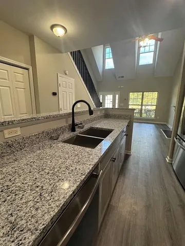 a kitchen with sink stove and cabinets