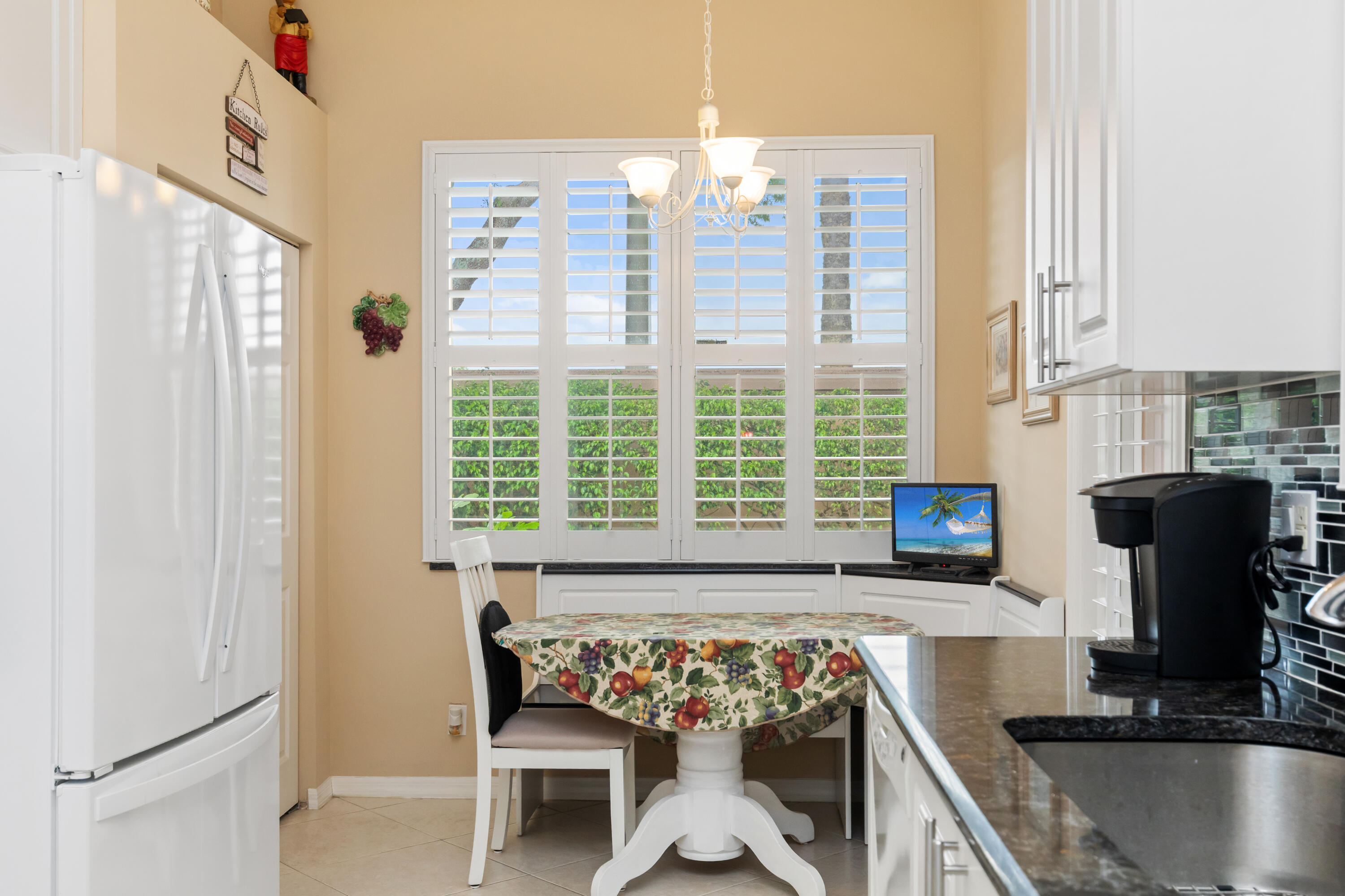6698 Vía Roma Delray Beach, FL 33446 - Photo 9 of 50 a bed sitting in a kitchen next to a window