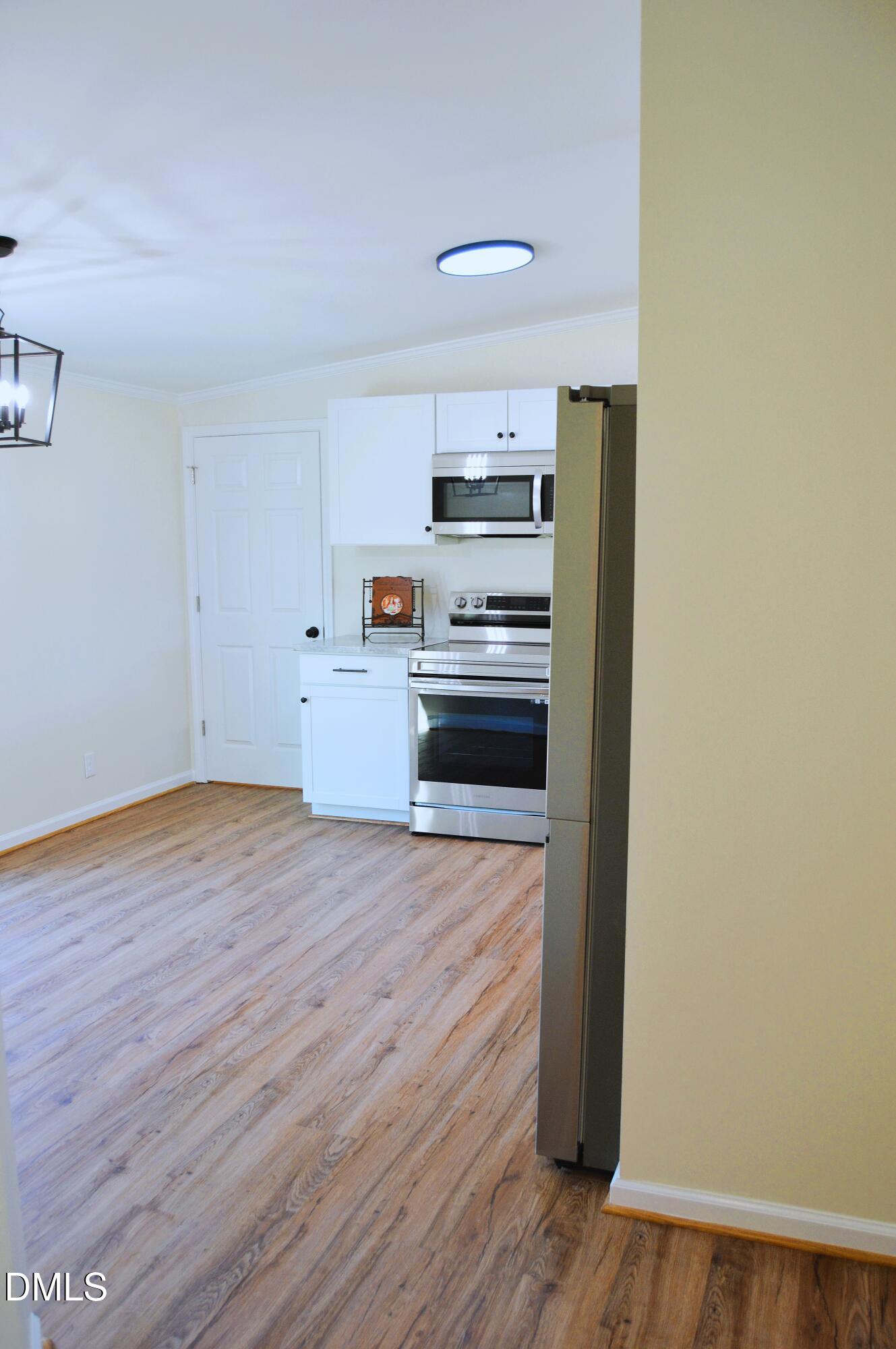 1159 No Bottom Road Warrenton, NC 27589 - Photo 17 of 43 a kitchen with wooden floors and appliances