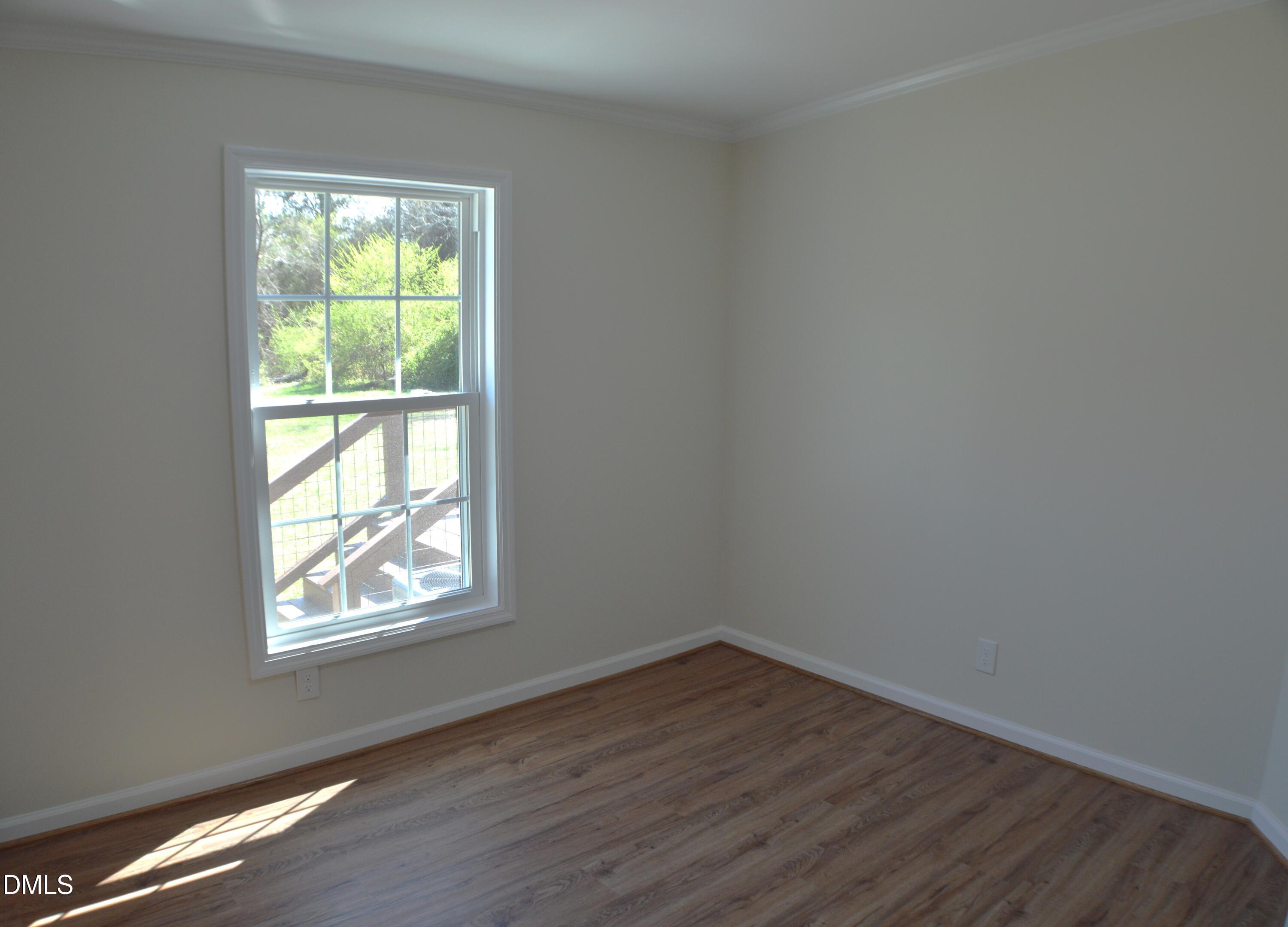 1159 No Bottom Road Warrenton, NC 27589 - Photo 23 of 43 an empty room with wooden floor and windows