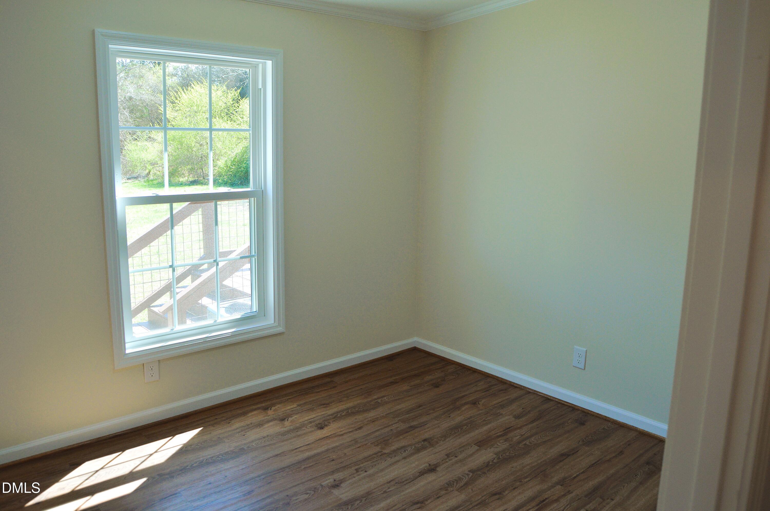 1159 No Bottom Road Warrenton, NC 27589 - Photo 24 of 43 an empty room with wooden floor and windows
