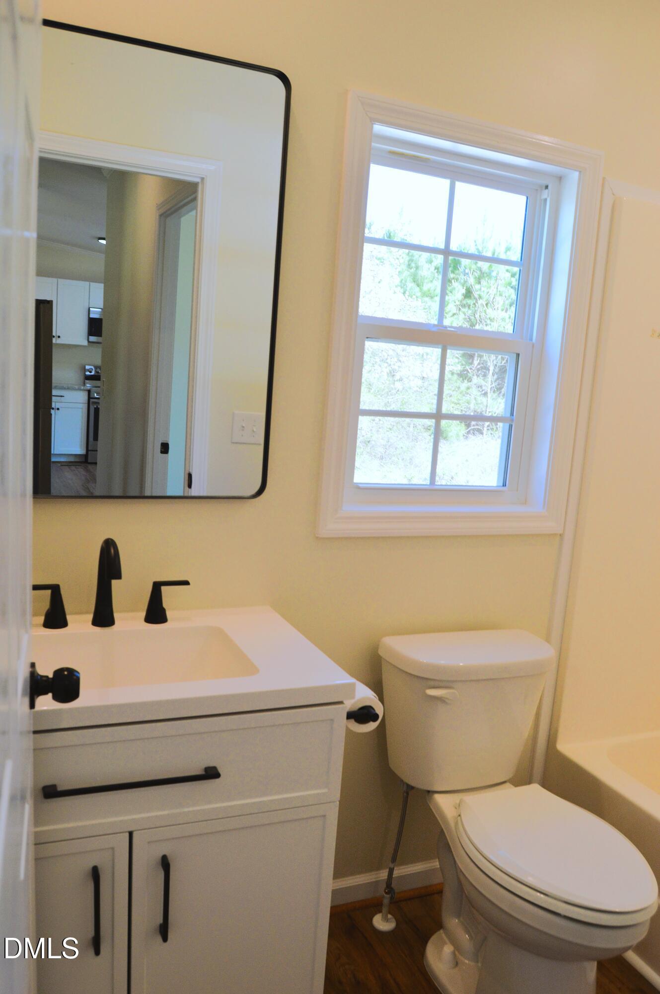 1159 No Bottom Road Warrenton, NC 27589 - Photo 24 of 44 a bathroom with a sink toilet and mirror