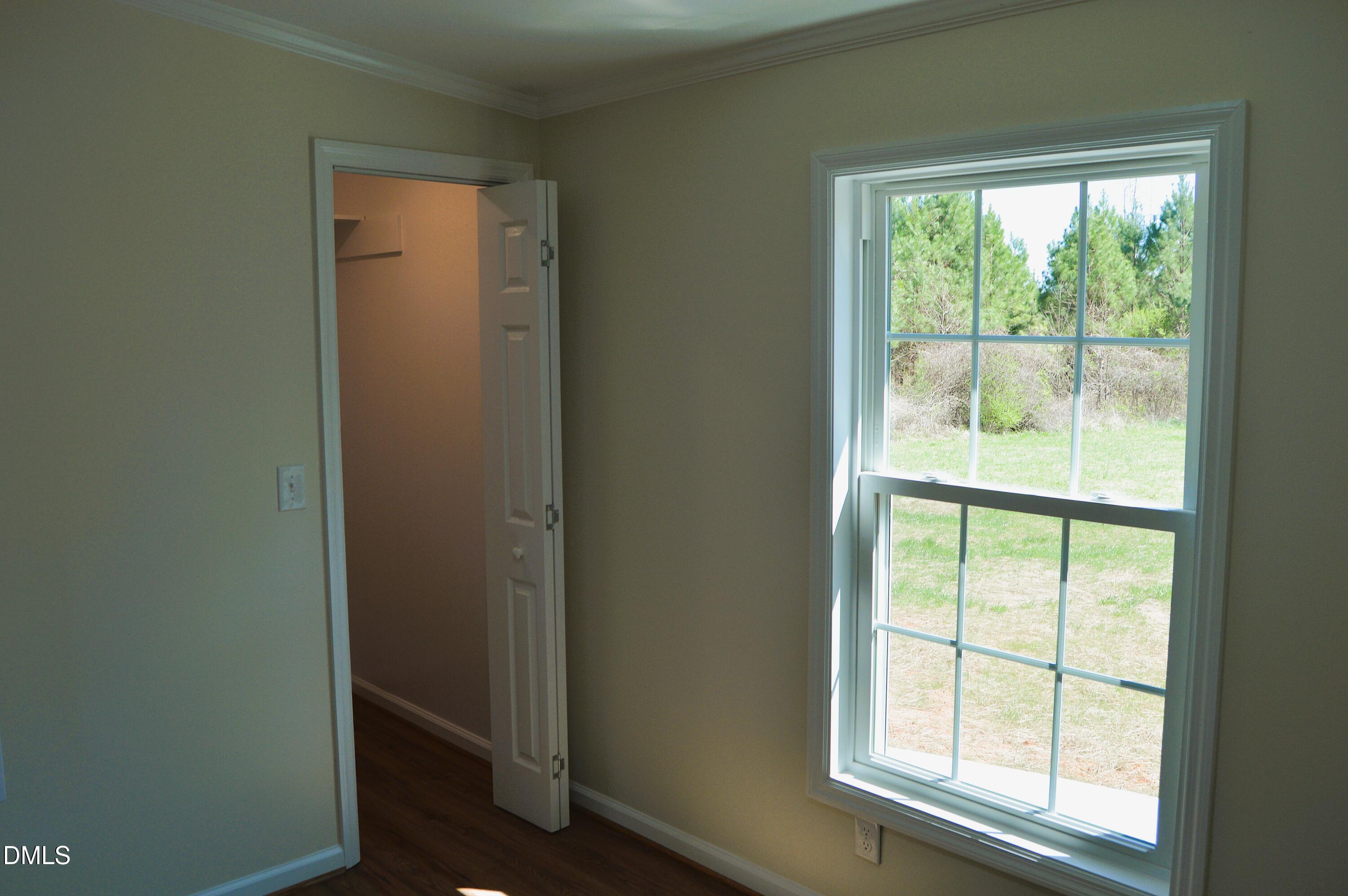 1159 No Bottom Road Warrenton, NC 27589 - Photo 27 of 44 an empty room with wooden floor and windows