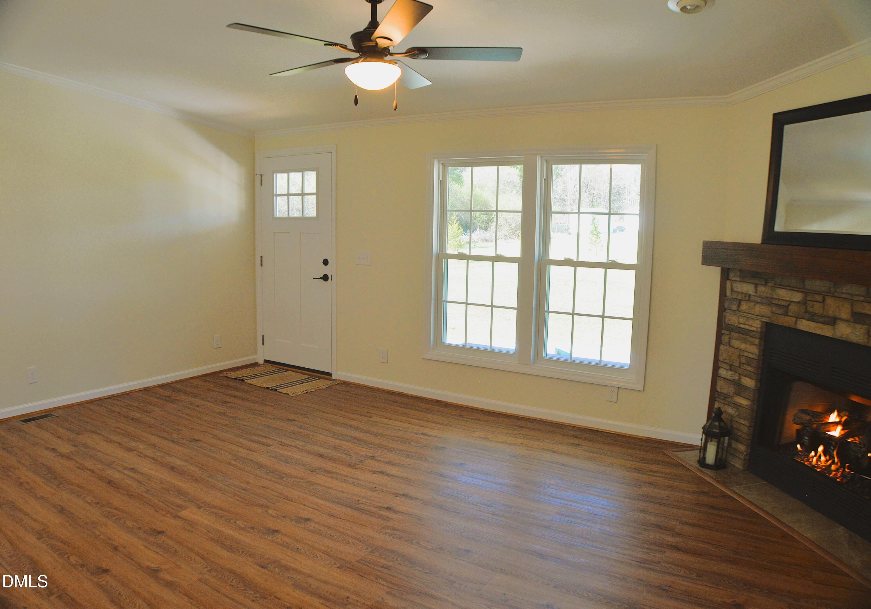 1159 No Bottom Road Warrenton, NC 27589 - Photo 5 of 43 a view of an empty room with a fireplace and a window