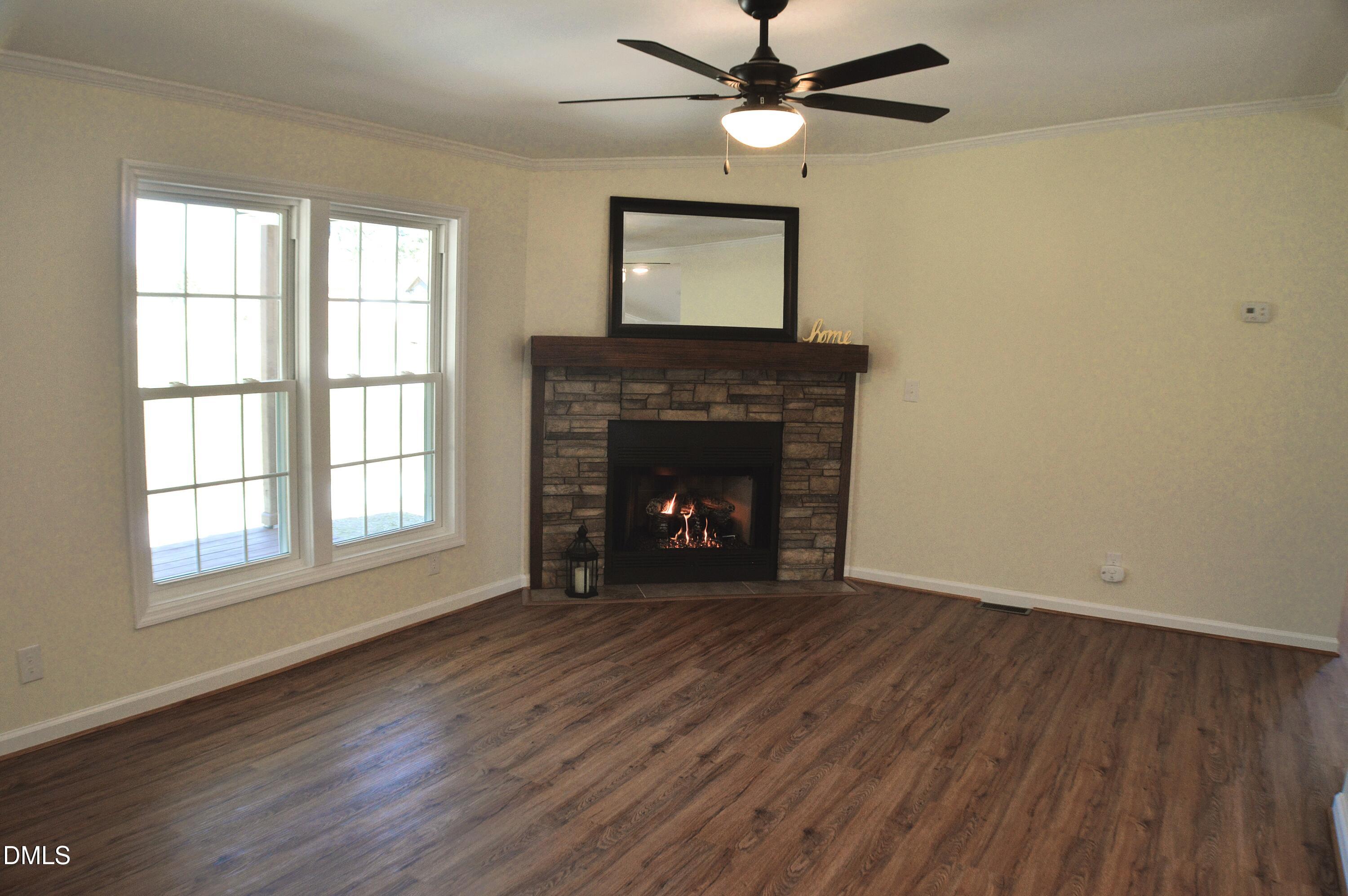 1159 No Bottom Road Warrenton, NC 27589 - Photo 7 of 43 wooden floor fireplace and windows in an empty room