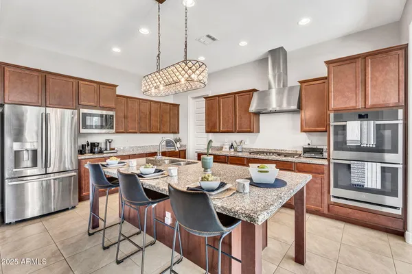 a kitchen with granite countertop a stove and cabinets