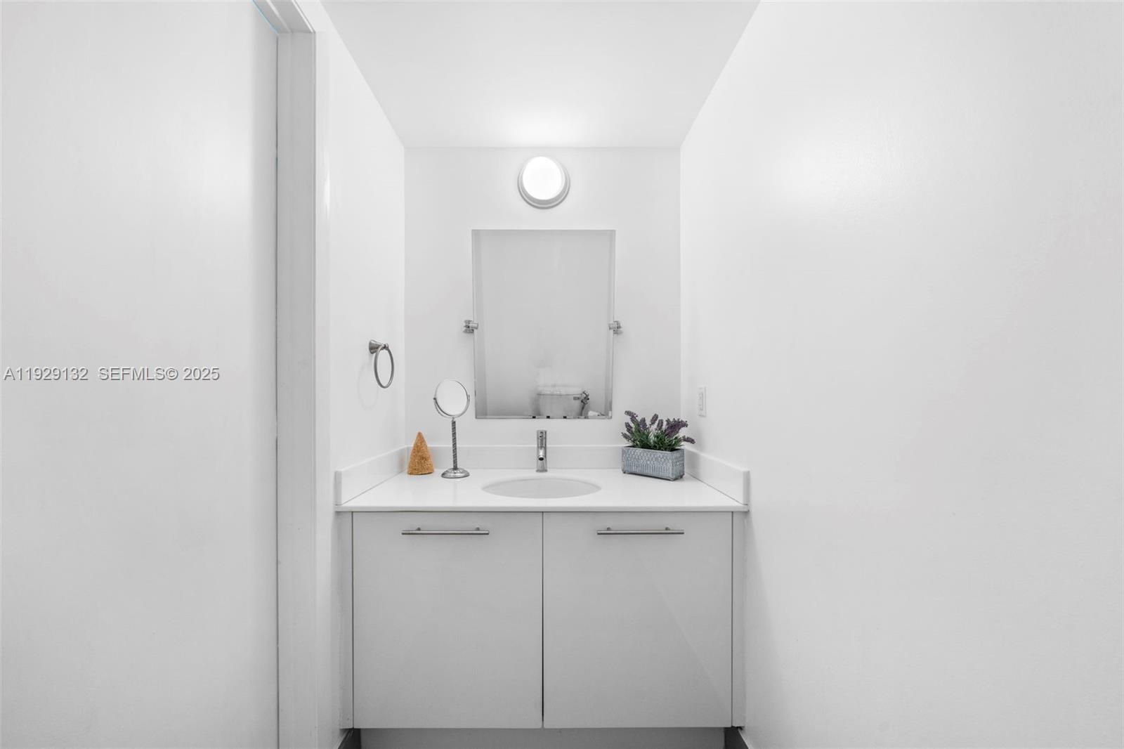 92 Southwest 3rd Street, Unit 4610 Miami, FL 33130 - Photo 12 of 16 a bathroom with a sink and a mirror