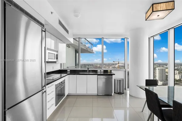 a kitchen with stainless steel appliances granite countertop a refrigerator and a stove top oven