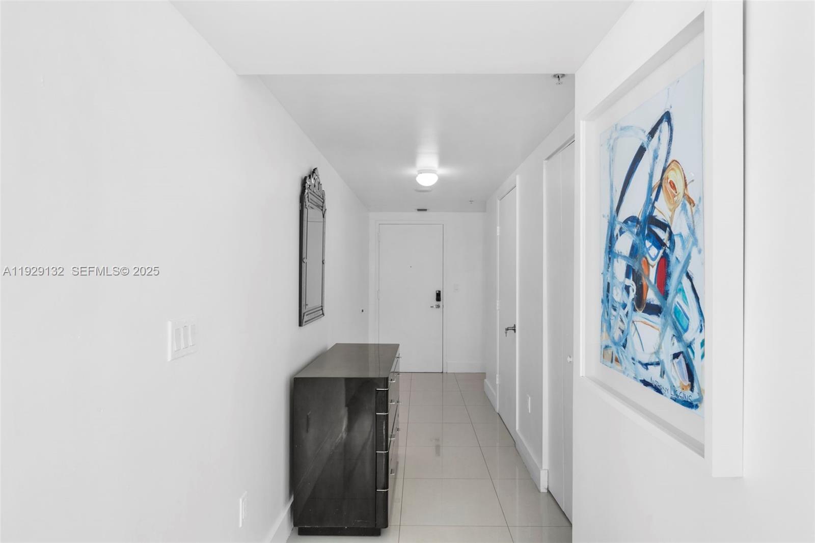 92 Southwest 3rd Street, Unit 4610 Miami, FL 33130 - Photo 5 of 16 a hallway with front door and wooden floor