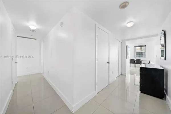 a view of a hallway and a kitchen with a sink