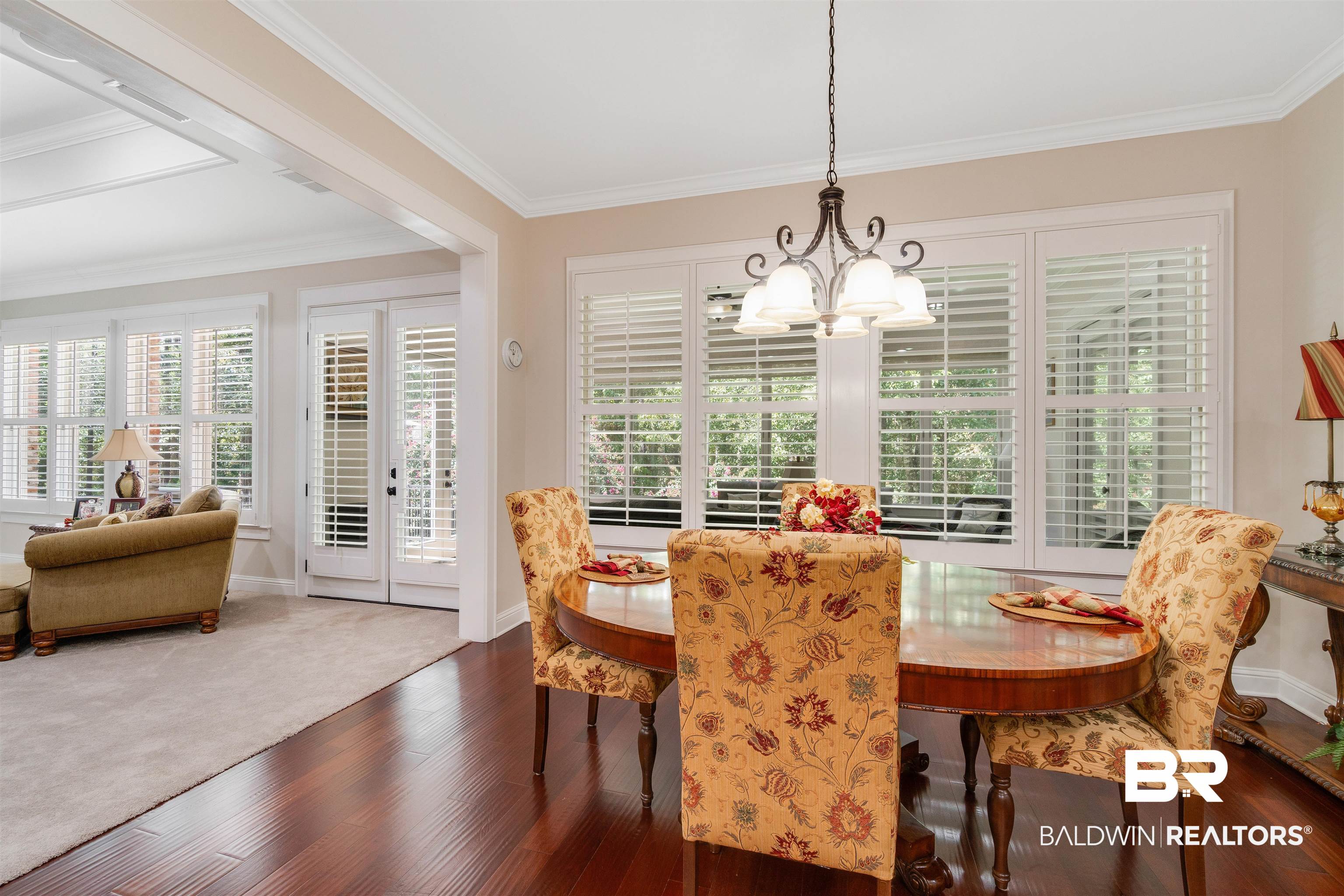 11281 Redfern Road Daphne, AL 36526 - Photo 14 of 80 Dining area featuring crown molding, dark wood-type flooring, and an inviting chandelier