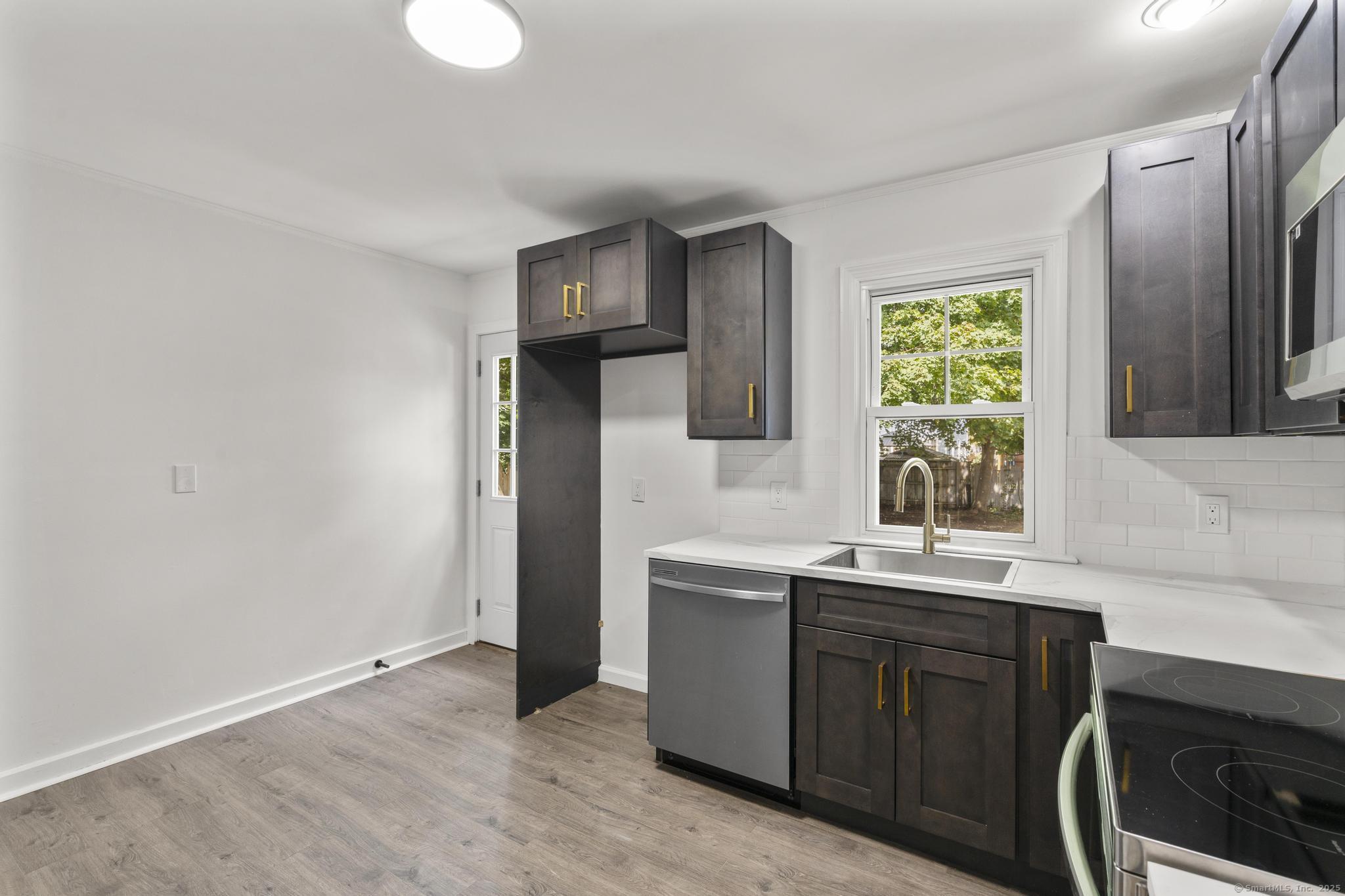 203 Gorham Avenue Hamden, CT 06514 - Photo 11 of 31 a kitchen with stainless steel appliances granite countertop a sink and a stove