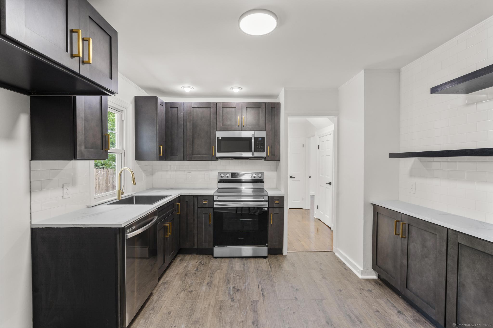 203 Gorham Avenue Hamden, CT 06514 - Photo 12 of 31 a kitchen with stainless steel appliances granite countertop a sink stove and refrigerator