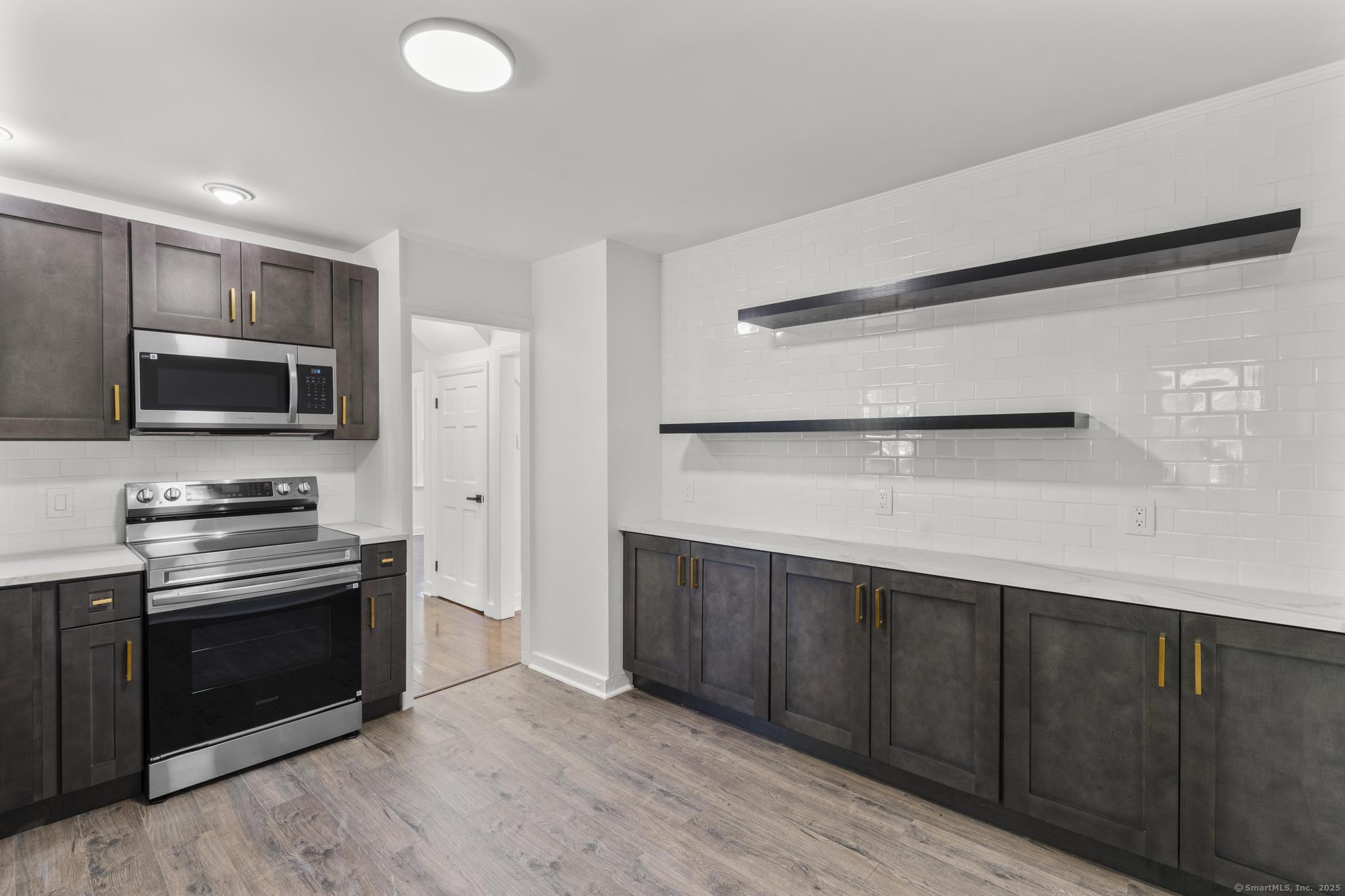 203 Gorham Avenue Hamden, CT 06514 - Photo 14 of 31 a kitchen with stainless steel appliances a stove microwave and refrigerator