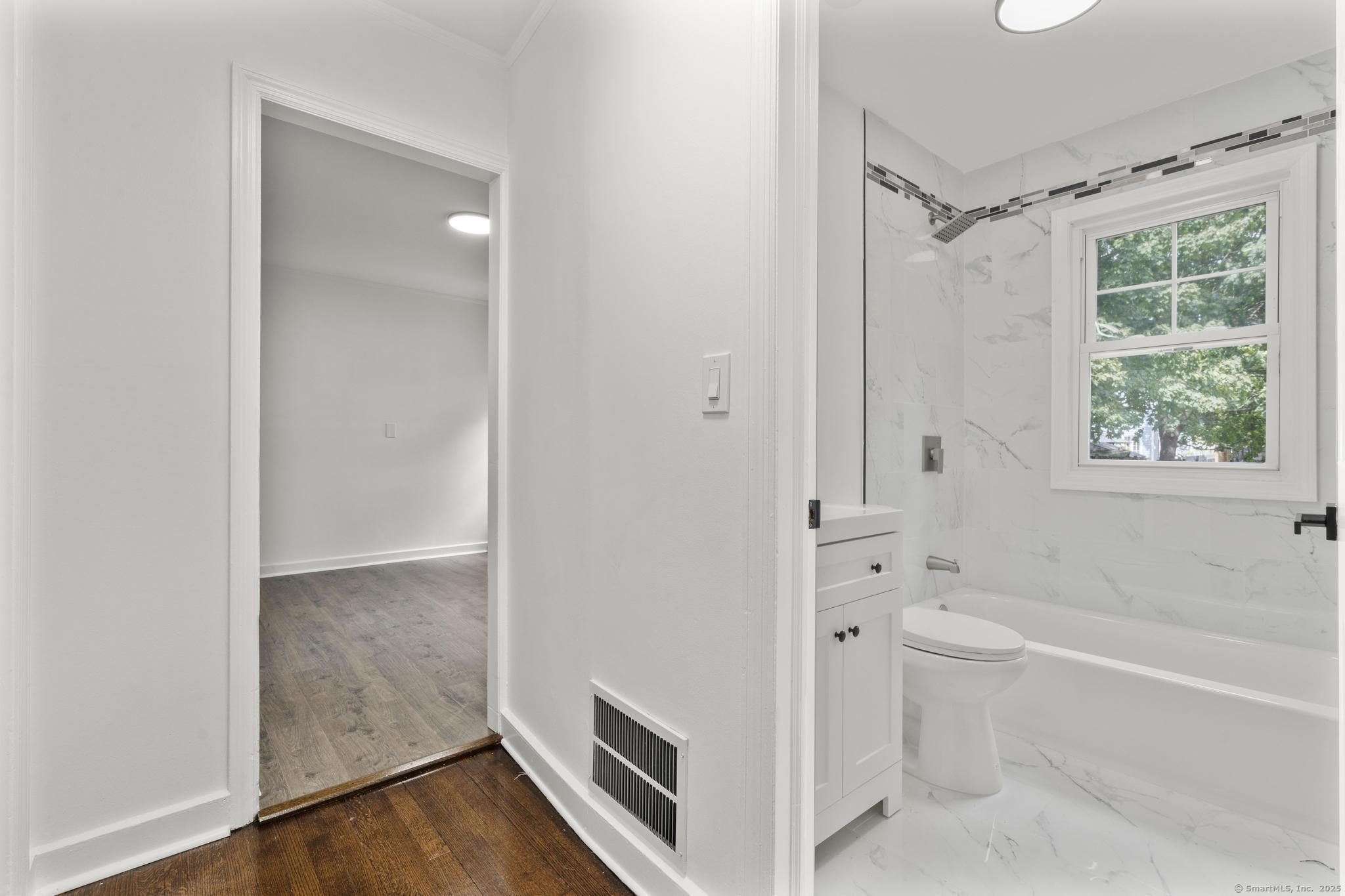 203 Gorham Avenue Hamden, CT 06514 - Photo 17 of 31 a bathroom with a tub a toilet and a shower