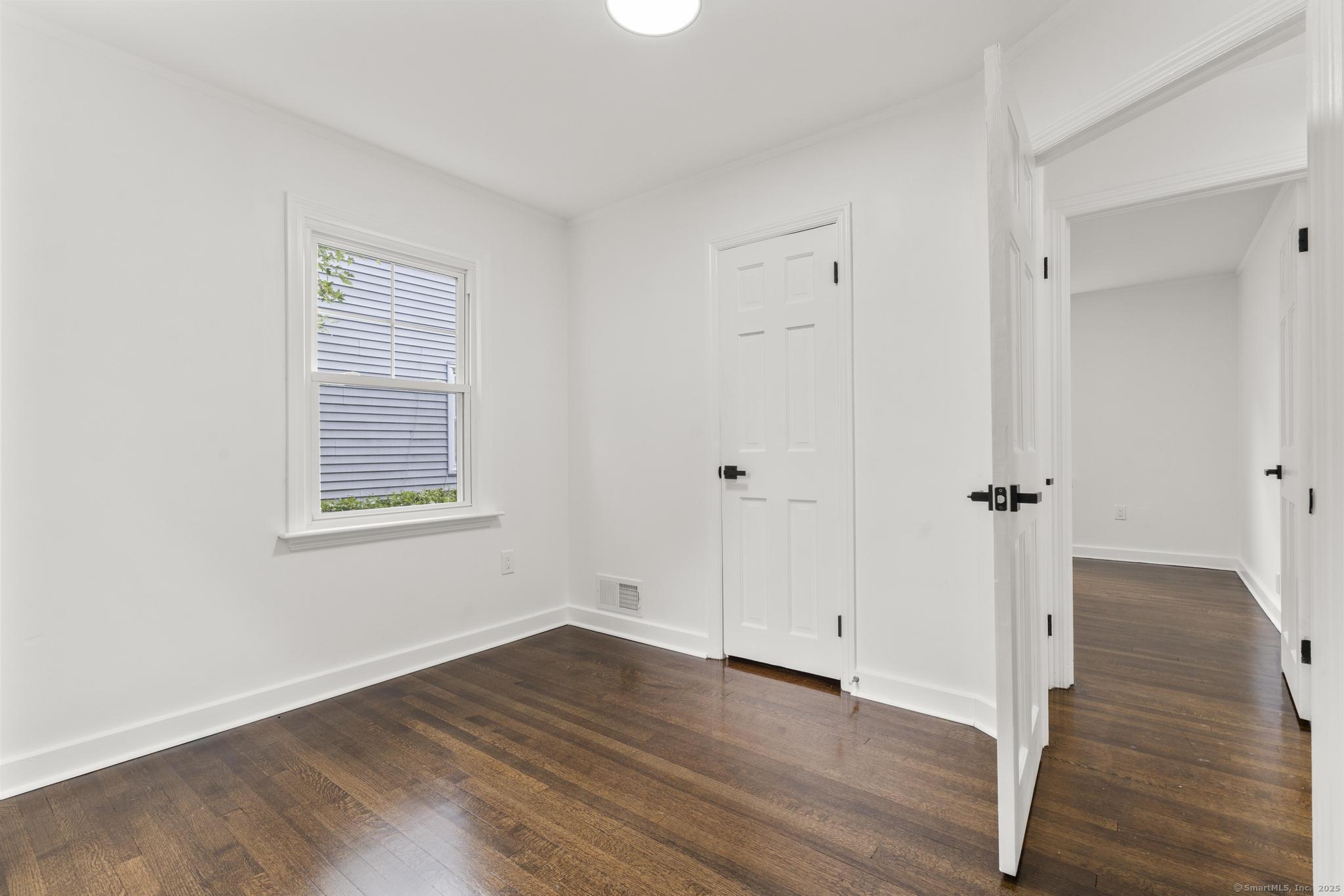 203 Gorham Avenue Hamden, CT 06514 - Photo 20 of 31 an empty room with wooden floor and a window