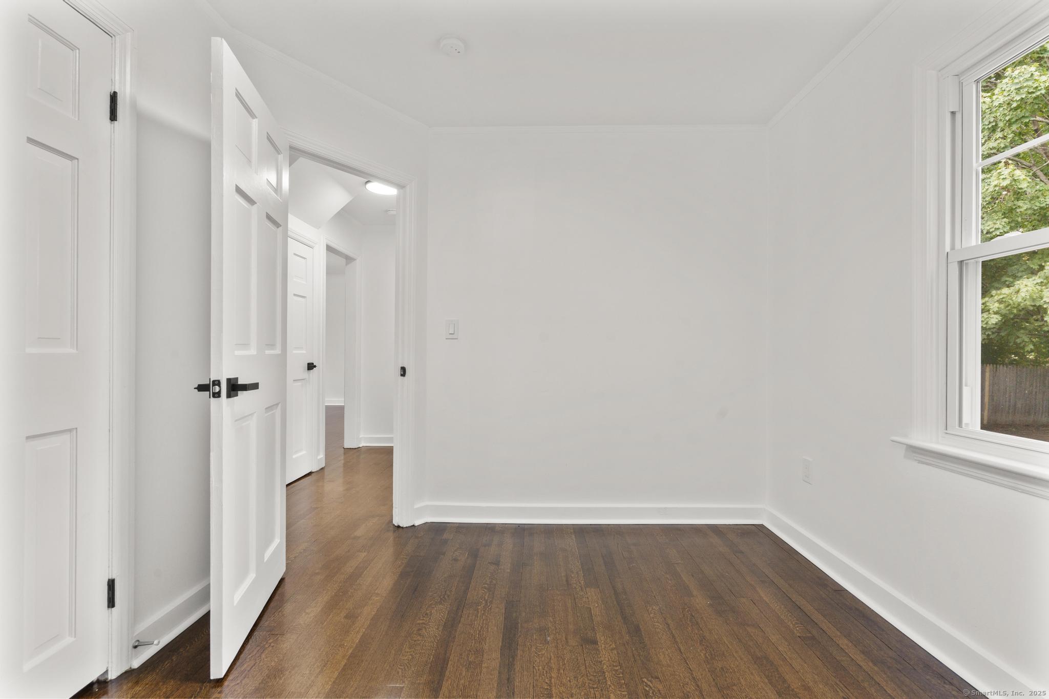 203 Gorham Avenue Hamden, CT 06514 - Photo 21 of 31 a view of a hallway with wooden floor and a window