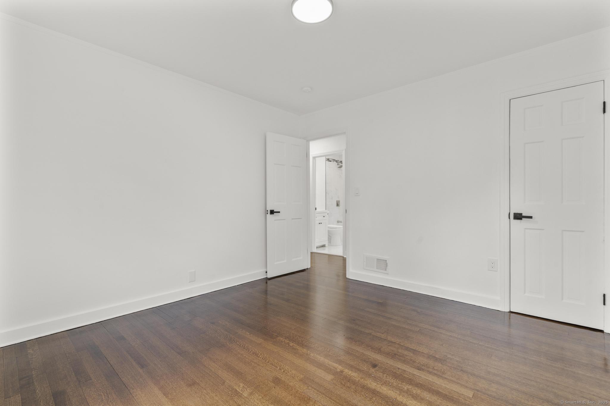 203 Gorham Avenue Hamden, CT 06514 - Photo 24 of 31 a view of an empty room with wooden floor