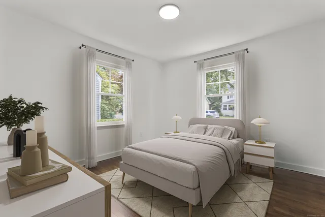 a bedroom with a bed and a potted plant