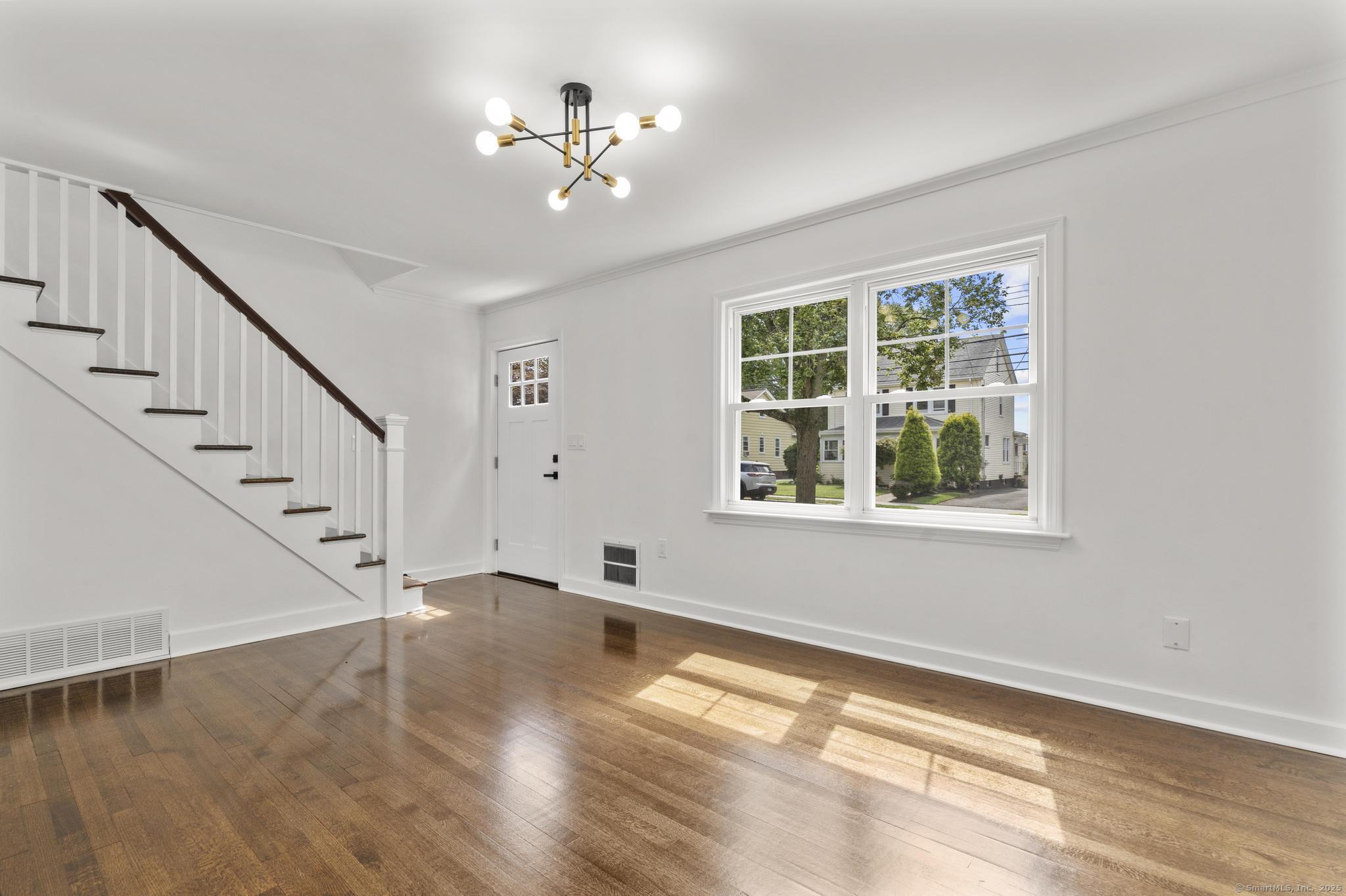 203 Gorham Avenue Hamden, CT 06514 - Photo 8 of 31 a view of an empty room with wooden floor and a window