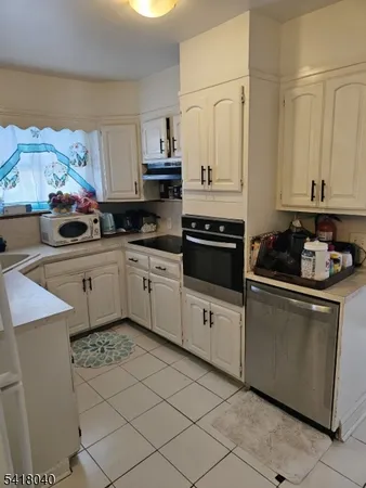 a kitchen with stainless steel appliances granite countertop a refrigerator sink and stove