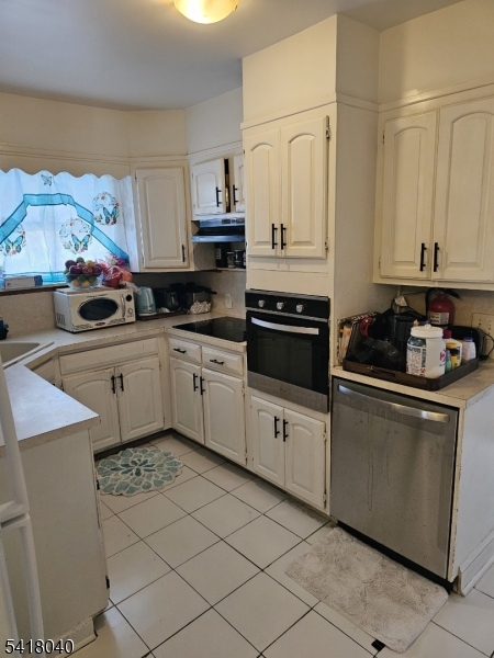 836 Summit Street Linden, NJ 07036 - Photo 7 of 10 a kitchen with stainless steel appliances a sink a stove a microwave and cabinets