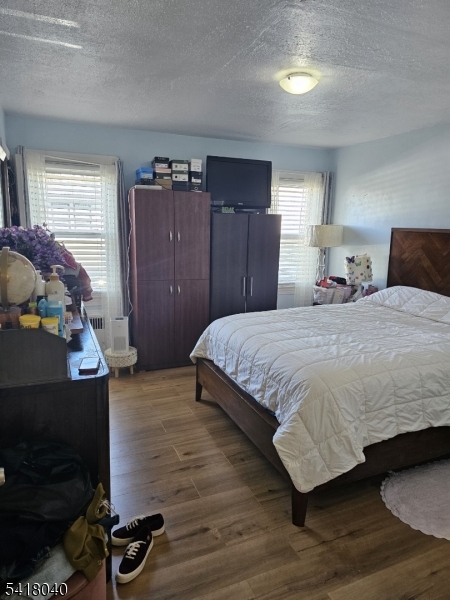 836 Summit Street Linden, NJ 07036 - Photo 9 of 10 a bedroom with a bed and wooden floor