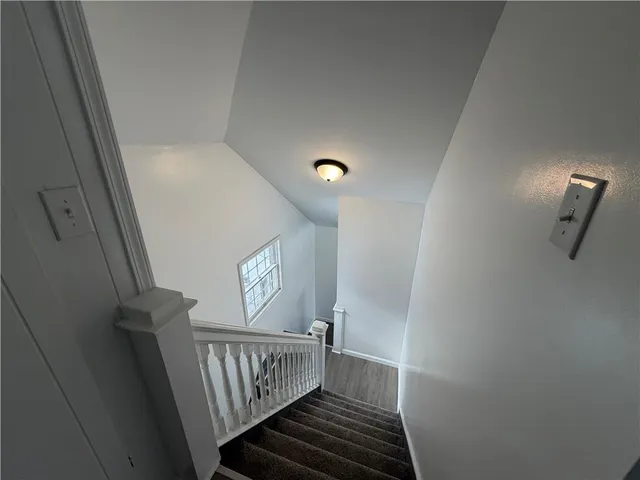 an empty room with a workspace & a window