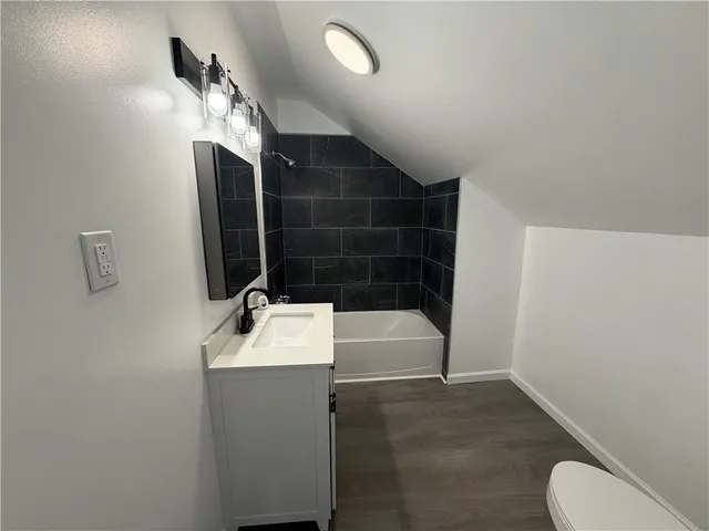 an empty room with wooden floor and closet